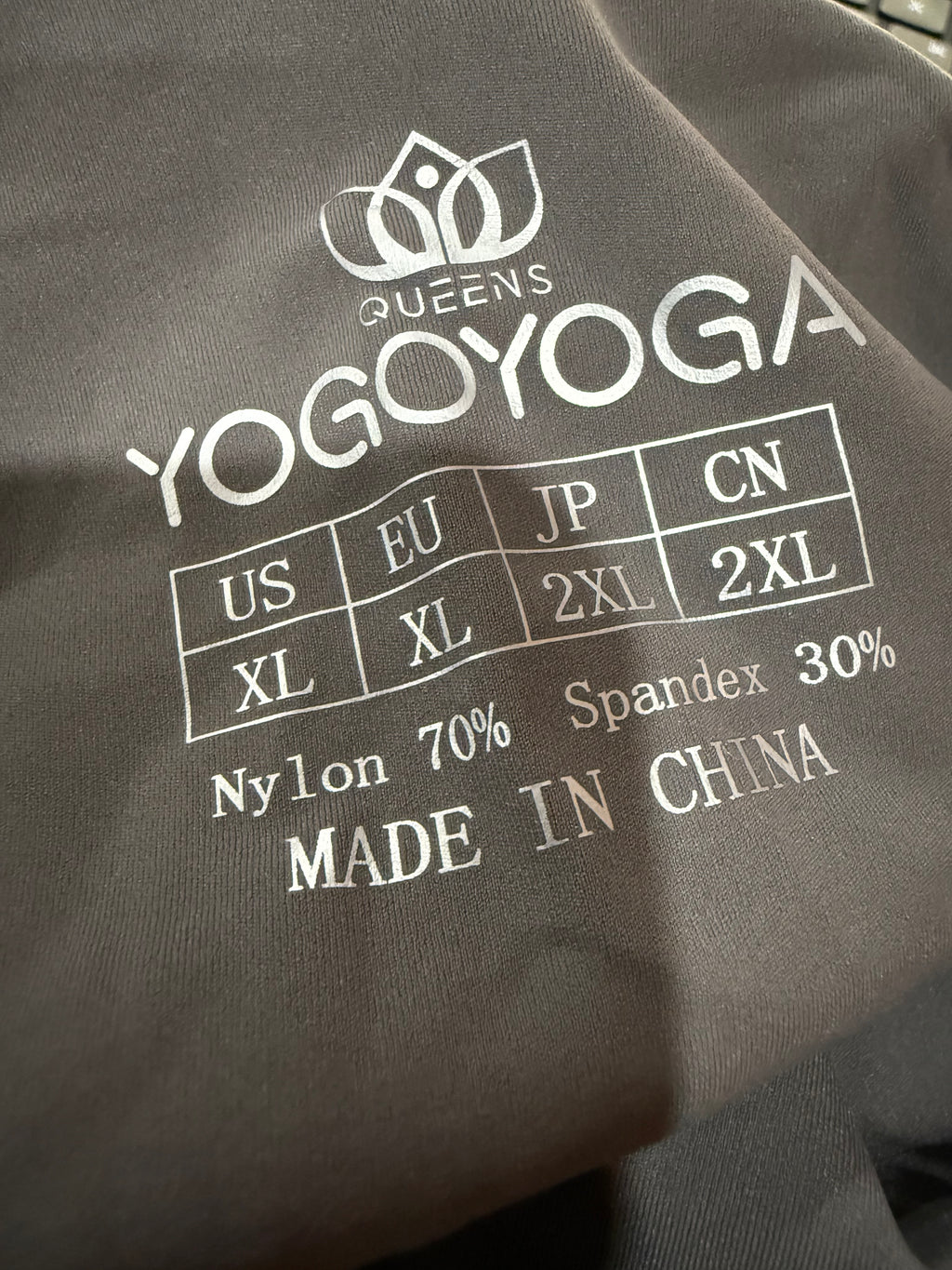 Gray fabric with white text and logos, including 'YoggoYoga' brand name.