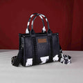 "Wrangler Cow Print Concealed Carry Tote/Crossbody Bag in Black — 2-in-1 western-style CCW bag by Wrangler"